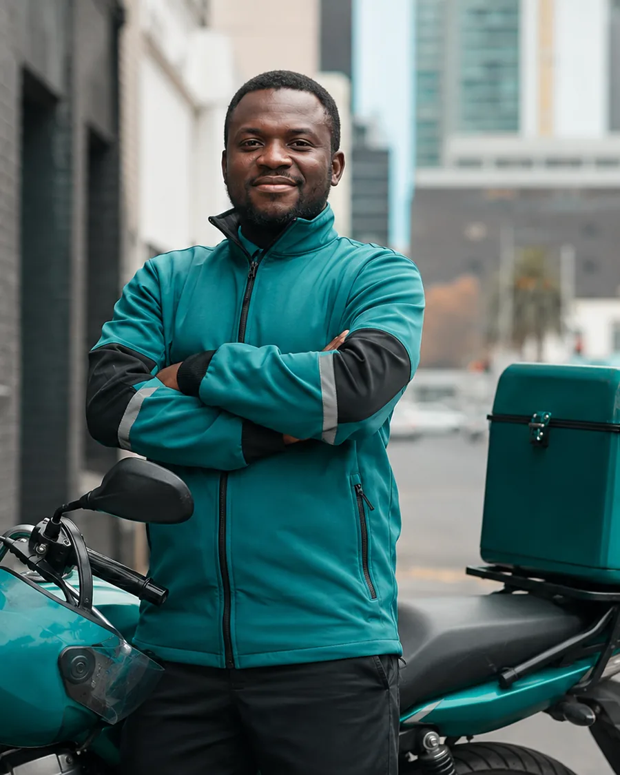 An established rider standing with his bike and box